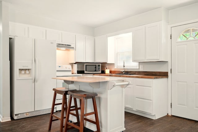 3249 Sandefer St, Abilene, TX 79603 - kitchen featuring white appliances, under cabinet range hood, a sink, and white cabinetry