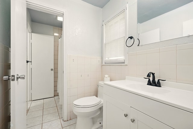 3249 Sandefer St, Abilene, TX 79603 - bathroom featuring tile walls, tile patterned floors, vanity, toilet, and wainscoting