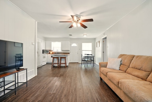 3249 Sandefer St, Abilene, TX 79603 - living area with ceiling fan, dark wood finished floors, and baseboards