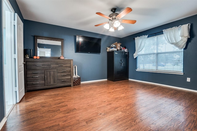 4430 Morning Star Ln, Midlothian, TX 76065 - unfurnished bedroom featuring wood finished floors, baseboards, and a ceiling fan