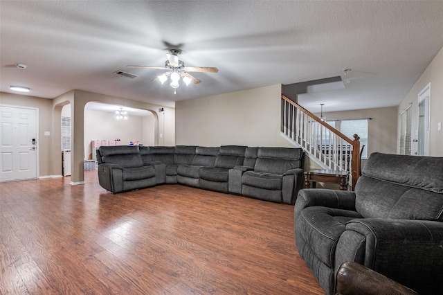 4430 Morning Star Ln, Midlothian, TX 76065 - living area featuring arched walkways, wood finished floors, ceiling fan, and stairway