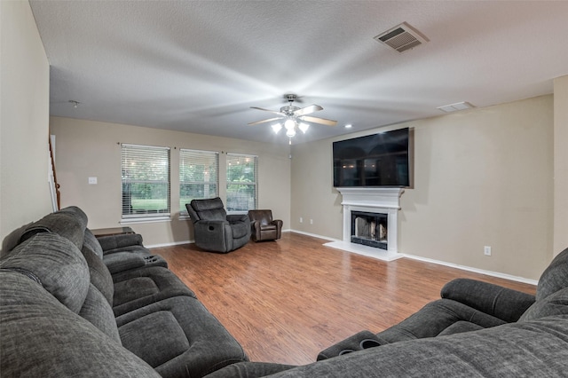 4430 Morning Star Ln, Midlothian, TX 76065 - living area with wood finished floors, a ceiling fan, baseboards, and a fireplace with raised hearth