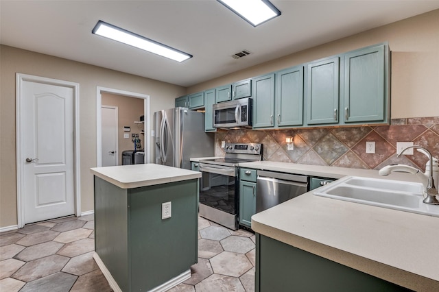 4430 Morning Star Ln, Midlothian, TX 76065 - kitchen with appliances with stainless steel finishes, a sink, light countertops, and a kitchen island