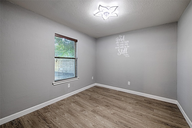 3019 Lela St, Irving, TX 75061 - empty room with wood finished floors and a textured ceiling