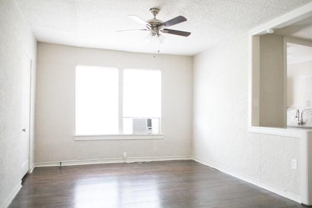 4107 Herschel Ave, Dallas, TX 75219 - empty room with wood finished floors, ceiling fan, baseboards, a textured ceiling, and cooling unit