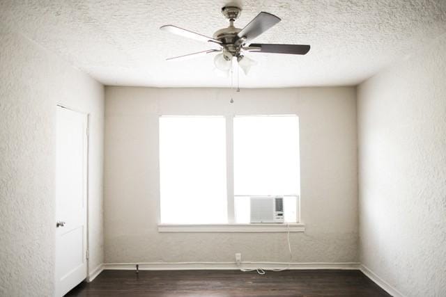 4107 Herschel Ave, Dallas, TX 75219 - empty room featuring a textured ceiling, dark wood-style floors, baseboards, ceiling fan, and a textured wall