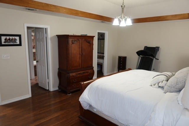 3035 Briarwood Dr, Paris, TX 75460 - bedroom with dark wood-type flooring and baseboards