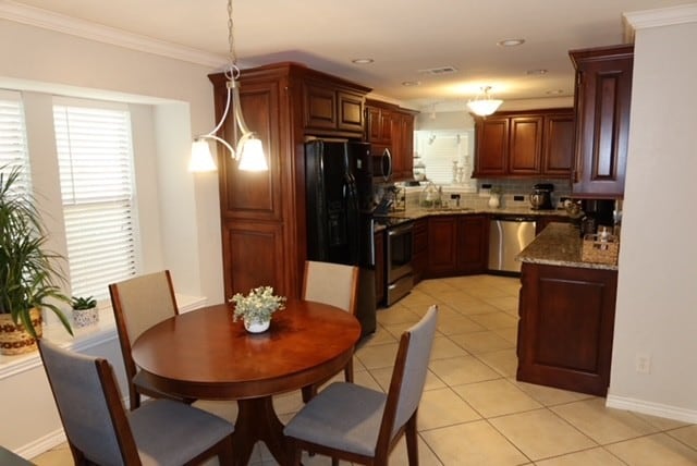 3035 Briarwood Dr, Paris, TX 75460 - kitchen featuring stainless steel appliances, backsplash, light tile patterned floors, pendant lighting, and stone countertops