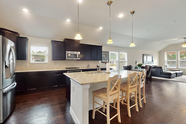 691 Hobie Point Dr, Lewisville, TX 75056 - kitchen featuring appliances with stainless steel finishes, lofted ceiling, a sink, open floor plan, and dark wood finished floors