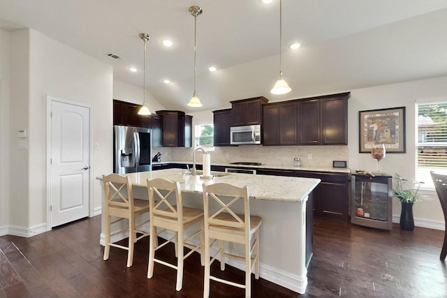 691 Hobie Point Dr, Lewisville, TX 75056 - kitchen featuring appliances with stainless steel finishes, beverage cooler, a sink, dark wood-style flooring, and dark brown cabinets