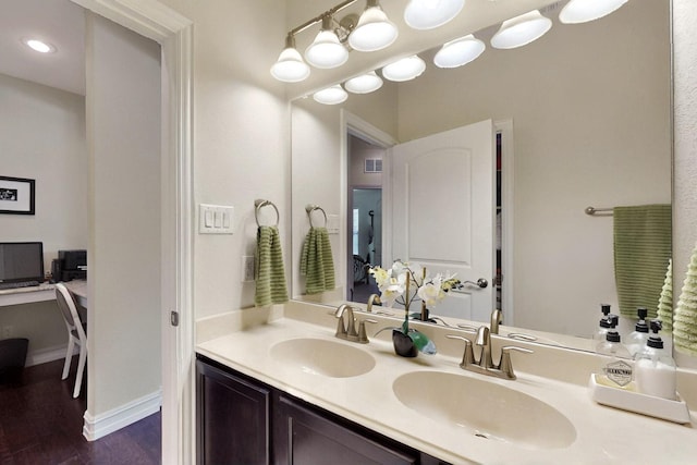 691 Hobie Point Dr, Lewisville, TX 75056 - bathroom featuring double vanity, wood finished floors, and baseboards