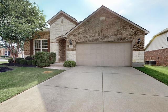 691 Hobie Point Dr, Lewisville, TX 75056 - french provincial home featuring stone siding, a garage, brick siding, concrete driveway, and a front lawn