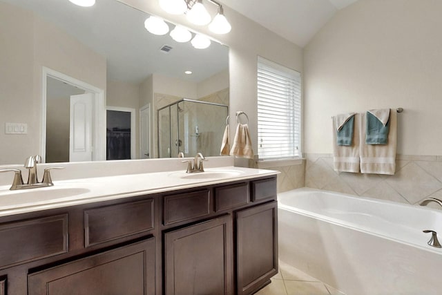691 Hobie Point Dr, Lewisville, TX 75056 - bathroom featuring a stall shower, a bath, double vanity, a walk in closet, and tile patterned flooring