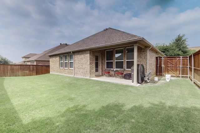 691 Hobie Point Dr, Lewisville, TX 75056 - rear view of property featuring brick siding, roof with shingles, and a patio area