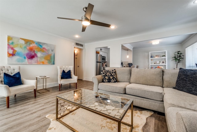 5927 E University Blvd Unit 217, Dallas, TX 75206 - living area featuring crown molding, wood finished floors, a ceiling fan, built in shelves, and baseboards