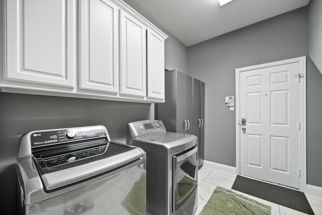 2425 Sir Lovel Ln, Lewisville, TX 75056 - laundry room featuring cabinet space, separate washer and dryer, light marble finish floors, and baseboards