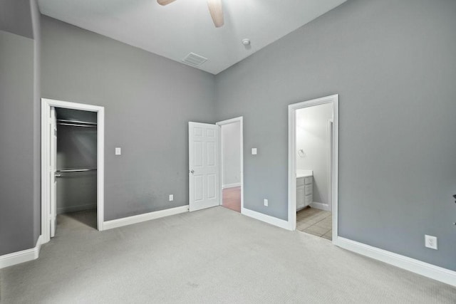 2425 Sir Lovel Ln, Lewisville, TX 75056 - unfurnished bedroom featuring carpet, a walk in closet, a closet, ensuite bath, and baseboards