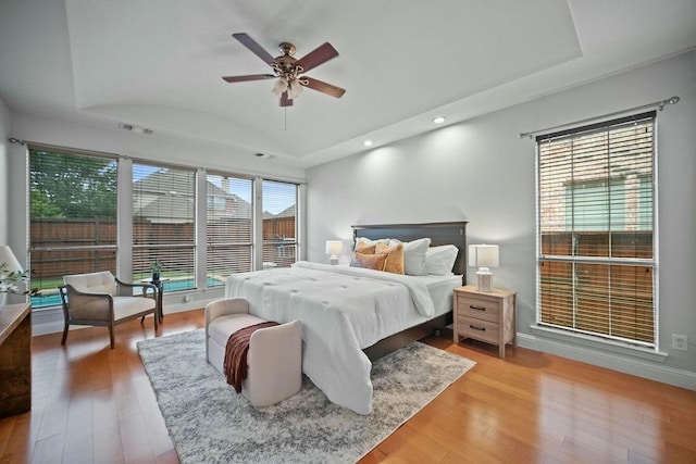2425 Sir Lovel Ln, Lewisville, TX 75056 - bedroom featuring vaulted ceiling, recessed lighting, light wood-style flooring, multiple windows, and baseboards