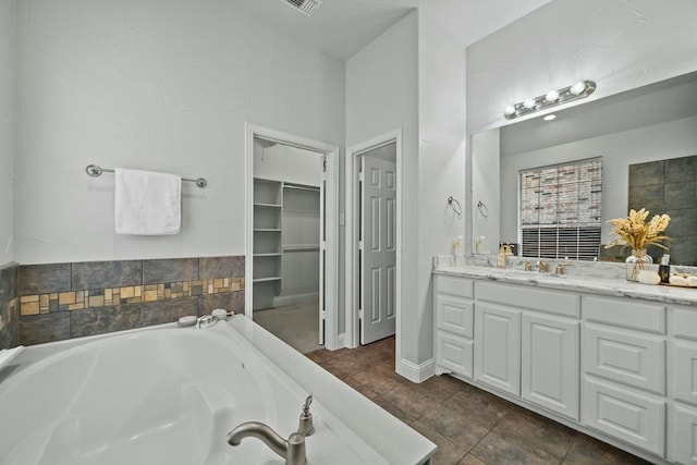 2425 Sir Lovel Ln, Lewisville, TX 75056 - bathroom with a bath, vanity, tile patterned floors, and a spacious closet