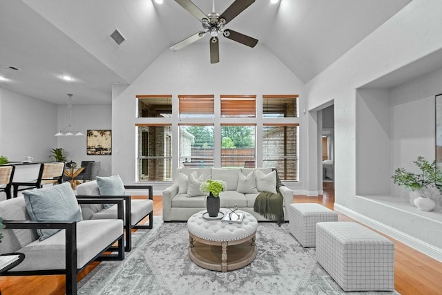 2425 Sir Lovel Ln, Lewisville, TX 75056 - living room with high vaulted ceiling, wood finished floors, ceiling fan, and baseboards