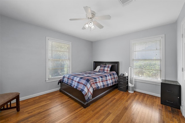 1025 N 32nd St, Waco, TX 76707 - bedroom with baseboards, dark wood-style flooring, and ceiling fan