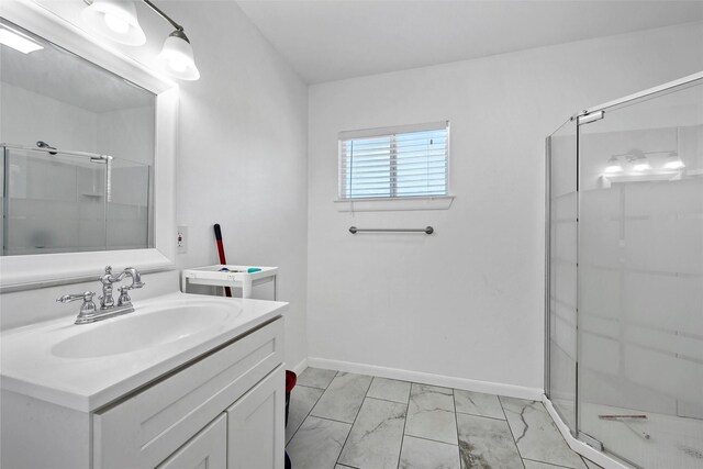 1025 N 32nd St, Waco, TX 76707 - full bath with marble finish flooring, vanity, a shower stall, and baseboards