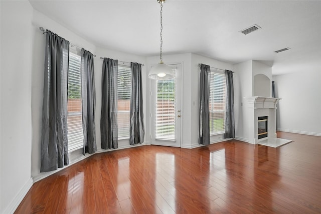 518 Hawthorne Dr, Murphy, TX 75094 - unfurnished dining area featuring wood finished floors, a fireplace with flush hearth, and baseboards