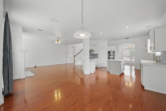 518 Hawthorne Dr, Murphy, TX 75094 - unfurnished living room with recessed lighting, a ceiling fan, a chandelier, light wood finished floors, and baseboards