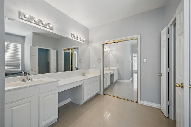 518 Hawthorne Dr, Murphy, TX 75094 - full bath featuring double vanity, healthy amount of natural light, baseboards, and tile patterned floors
