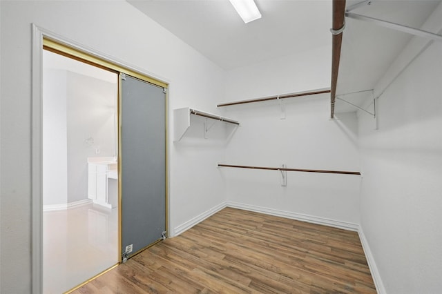 518 Hawthorne Dr, Murphy, TX 75094 - walk in closet with wood finished floors