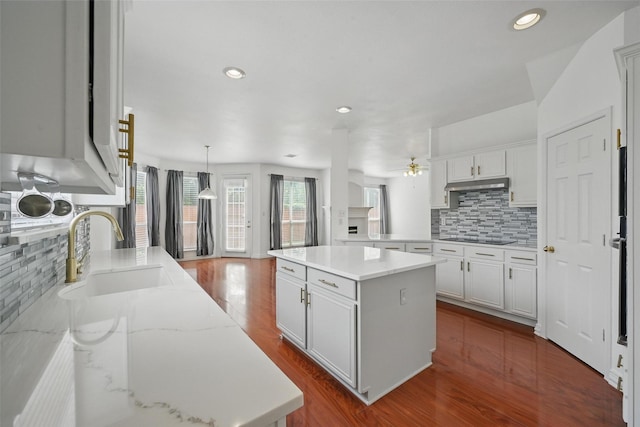 518 Hawthorne Dr, Murphy, TX 75094 - kitchen featuring a sink, a ceiling fan, decorative backsplash, a kitchen island, and black electric stovetop