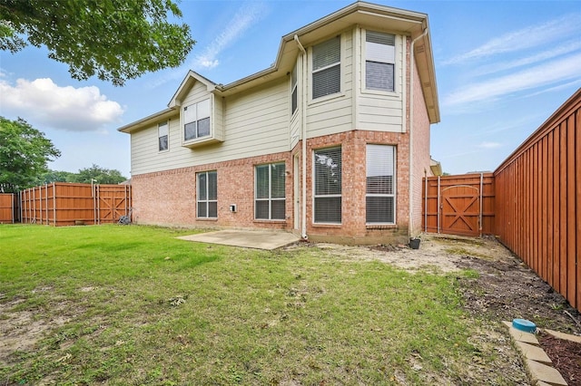 518 Hawthorne Dr, Murphy, TX 75094 - back of property featuring a gate, brick siding, and a patio area