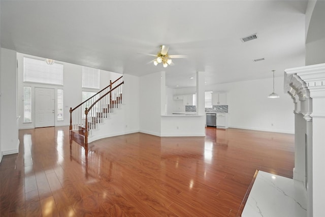 518 Hawthorne Dr, Murphy, TX 75094 - unfurnished living room featuring stairway, ceiling fan, wood finished floors, baseboards, and plenty of natural light