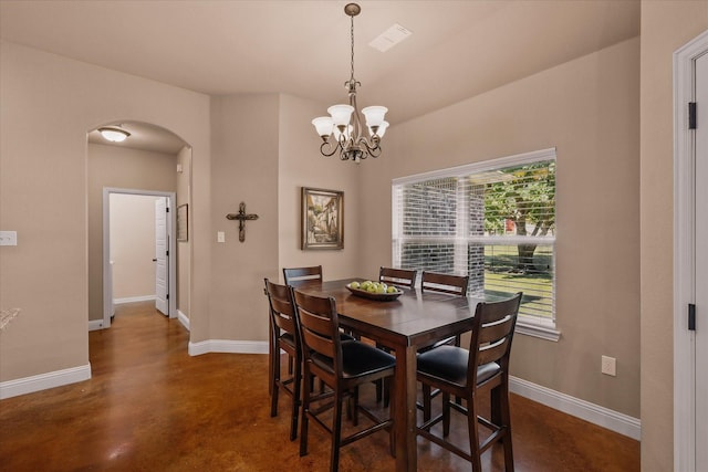5861 Hayes Rd, Midlothian, TX 76065 - dining room featuring arched walkways, finished concrete flooring, baseboards, and a chandelier