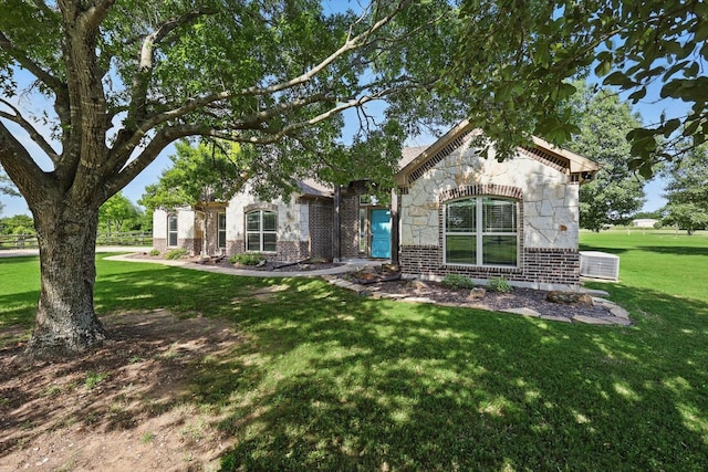 5861 Hayes Rd, Midlothian, TX 76065 - view of front of house featuring brick siding, a front lawn, central AC unit, and stone siding