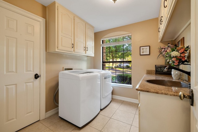 201 Split Rock Ter, Ovilla, TX 75154 - laundry area featuring washer and clothes dryer, cabinet space, baseboards, and light tile patterned floors