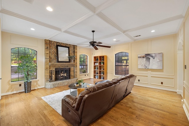 201 Split Rock Ter, Ovilla, TX 75154 - living area with a decorative wall, coffered ceiling, light wood-type flooring, a brick fireplace, and ceiling fan