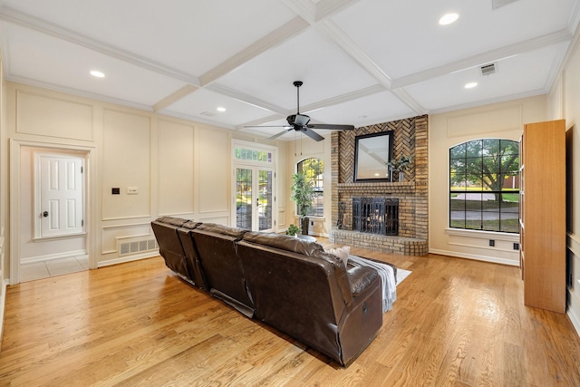 201 Split Rock Ter, Ovilla, TX 75154 - living room featuring a decorative wall, ceiling fan, a brick fireplace, light wood-type flooring, and coffered ceiling