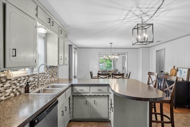 809 S Prairieville St, Athens, TX 75751 - kitchen featuring stainless steel dishwasher, a sink, a chandelier, a peninsula, and dark countertops
