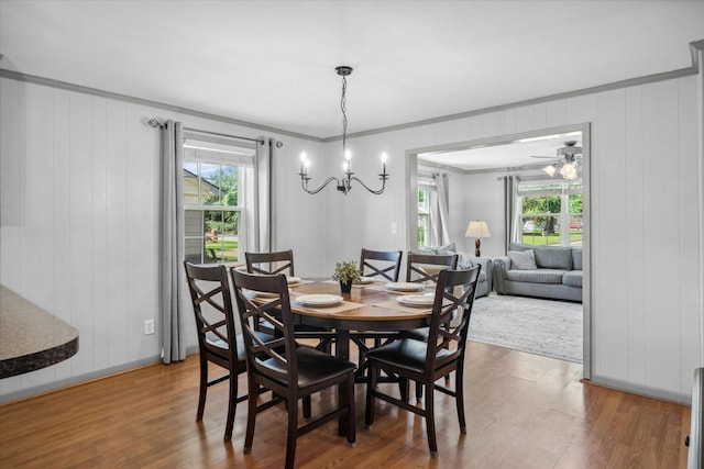 809 S Prairieville St, Athens, TX 75751 - dining space featuring wood finished floors, ornamental molding, a chandelier, and a decorative wall