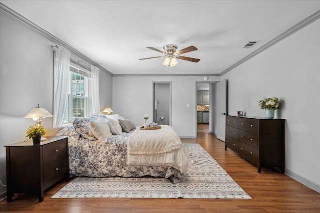 809 S Prairieville St, Athens, TX 75751 - bedroom with ornamental molding, wood finished floors, baseboards, and a ceiling fan