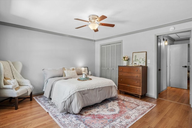 809 S Prairieville St, Athens, TX 75751 - bedroom with ornamental molding, a closet, light wood finished floors, a ceiling fan, and baseboards