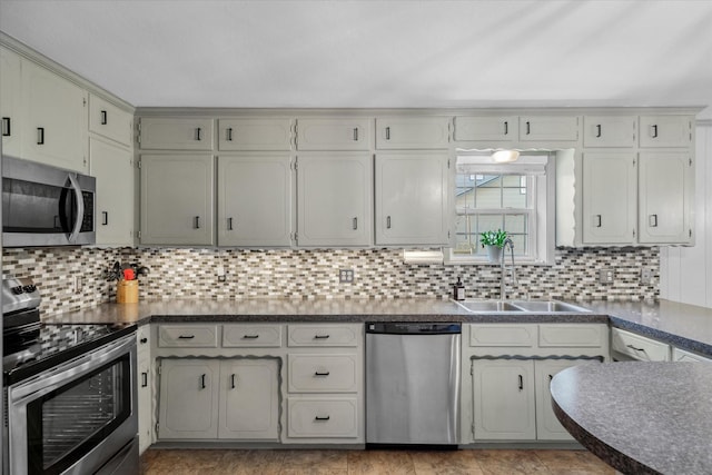 809 S Prairieville St, Athens, TX 75751 - kitchen featuring appliances with stainless steel finishes, a sink, dark countertops, and backsplash