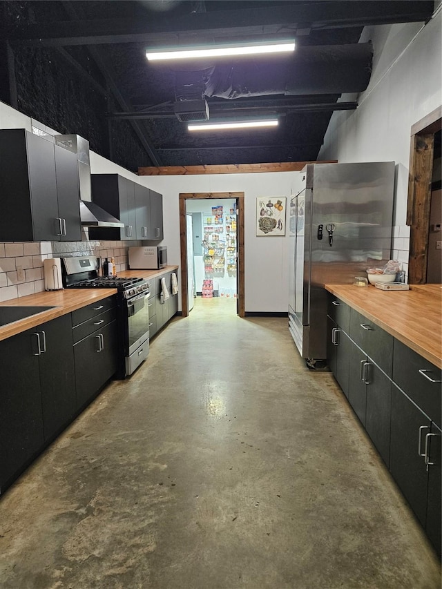 13597 County Road 35, Tyler, TX 75706 - kitchen featuring stainless steel appliances, wooden counters, concrete floors, and dark cabinetry