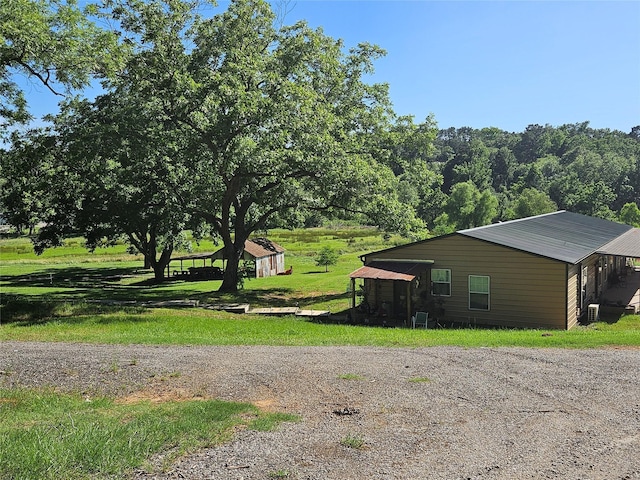 13597 County Road 35, Tyler, TX 75706 - view of side of property featuring an outdoor structure and a lawn