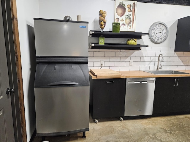 13597 County Road 35, Tyler, TX 75706 - kitchen with butcher block counters, a sink, dark cabinetry, open shelves, and stainless steel dishwasher