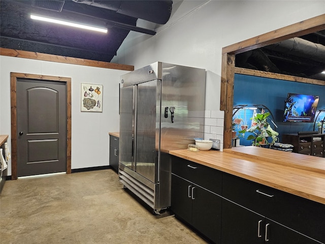 13597 County Road 35, Tyler, TX 75706 - kitchen with wood counters, high end fridge, dark cabinets, and vaulted ceiling