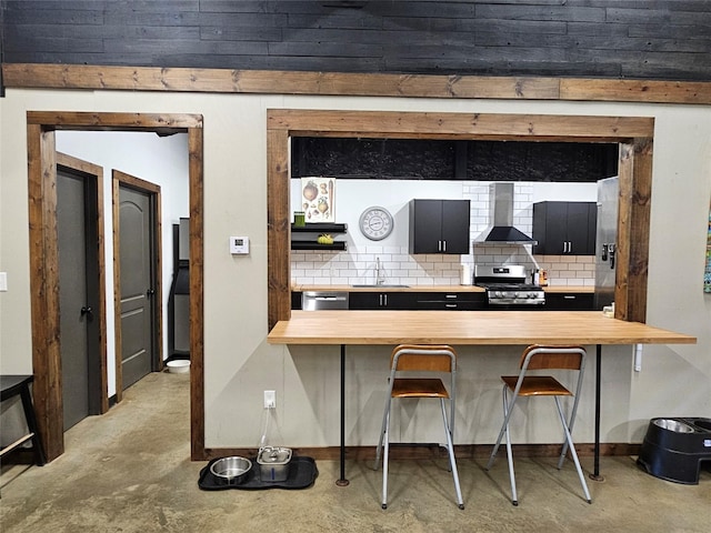 13597 County Road 35, Tyler, TX 75706 - kitchen featuring wall chimney exhaust hood, butcher block counters, stainless steel appliances, and concrete flooring