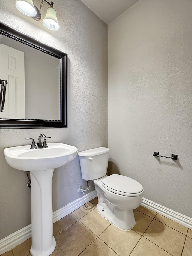 5973 Country View Ln, Frisco, TX 75036 - half bath featuring toilet, tile patterned floors, and baseboards