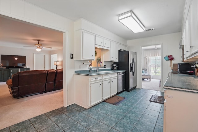 3720 Wharton Dr, Fort Worth, TX 76133 - kitchen with a sink, appliances with stainless steel finishes, white cabinets, ceiling fan, and dark carpet